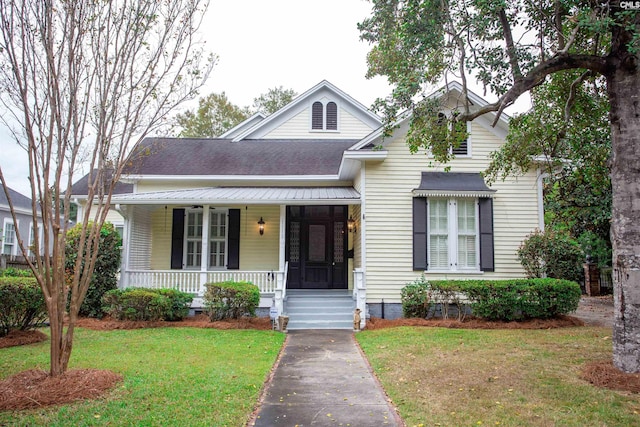 view of front of property with covered porch and a front yard