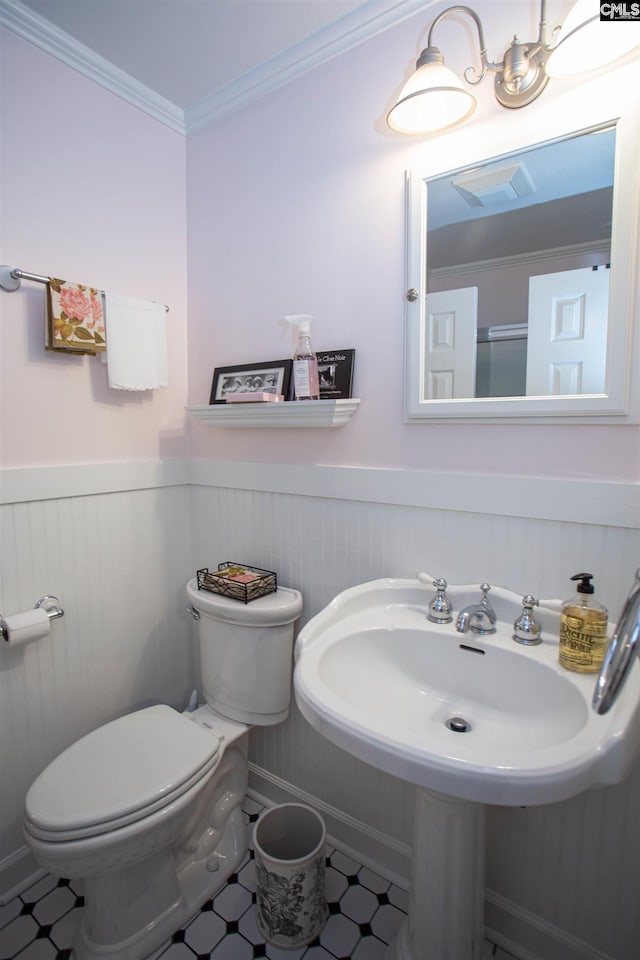 bathroom featuring toilet and ornamental molding