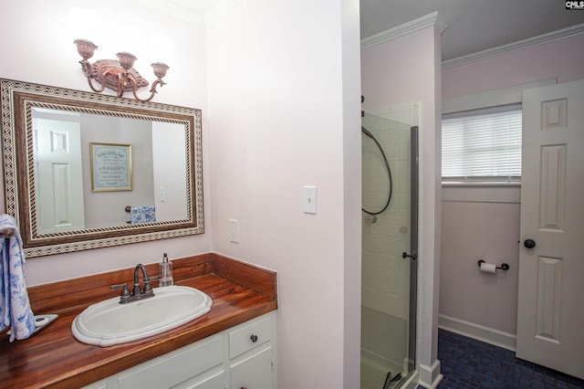 bathroom with a shower with door, vanity, and crown molding