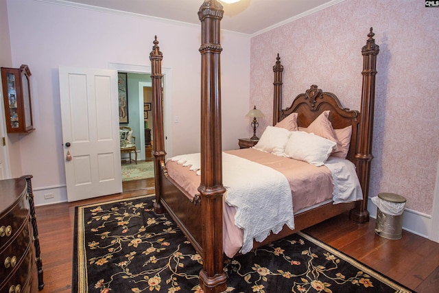 bedroom with crown molding and dark hardwood / wood-style floors