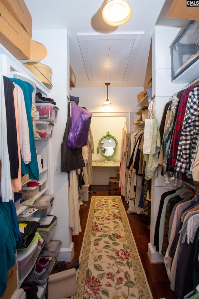 walk in closet with dark wood-type flooring