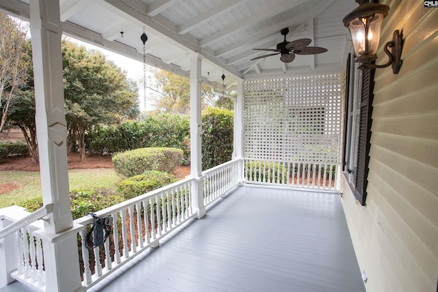 wooden terrace with covered porch and ceiling fan