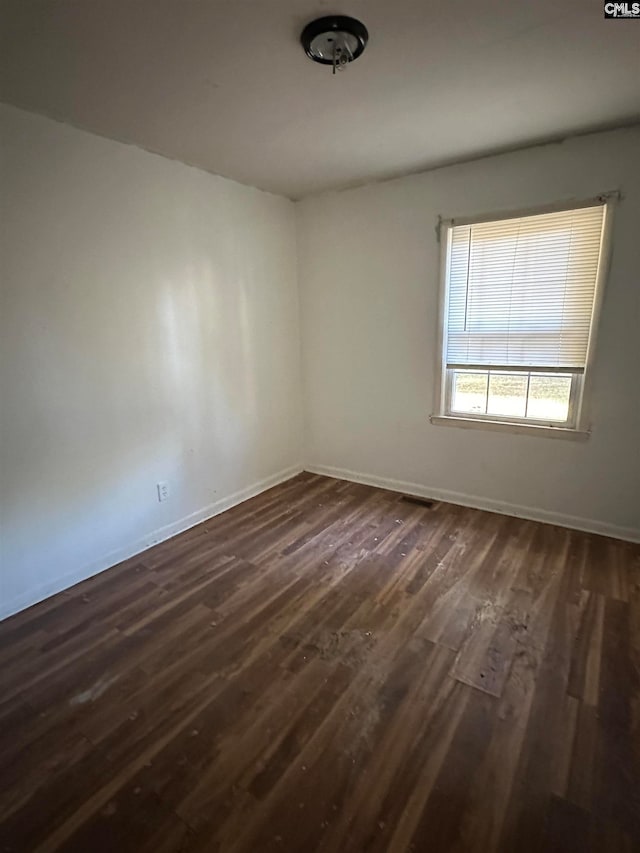 empty room with dark wood-type flooring