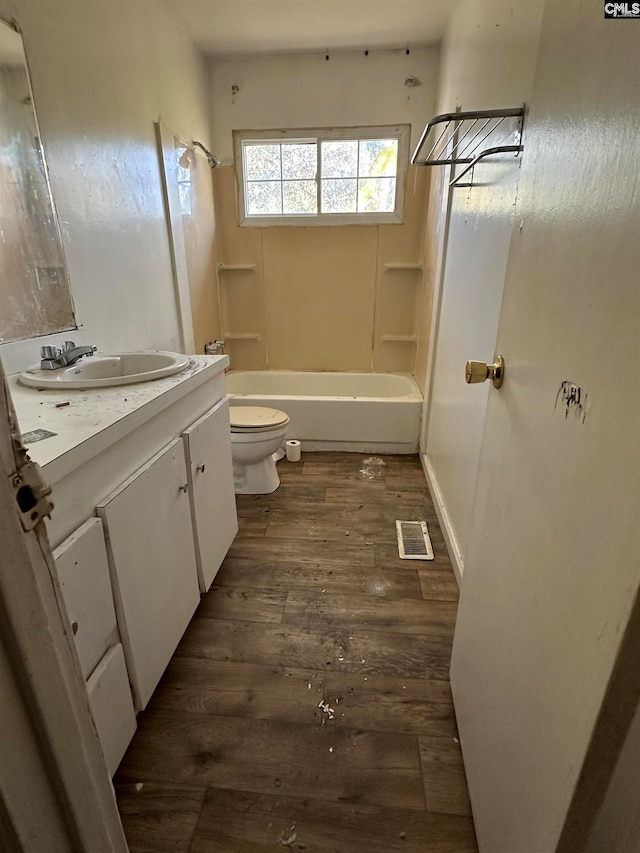 full bathroom featuring vanity, toilet, hardwood / wood-style flooring, and tub / shower combination