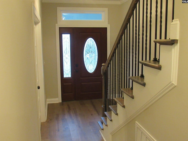 entryway featuring hardwood / wood-style floors and crown molding