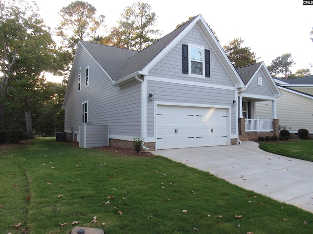 craftsman inspired home featuring a porch, a garage, and a front lawn