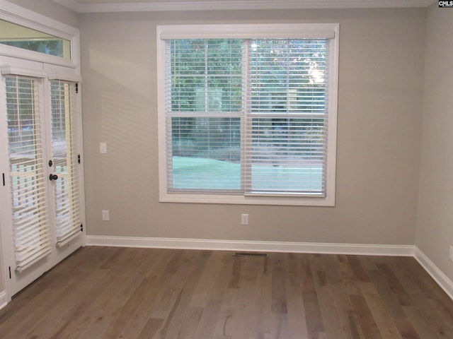 interior space featuring dark hardwood / wood-style flooring and ornamental molding