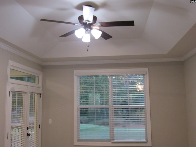 interior details featuring a raised ceiling, ceiling fan, and ornamental molding