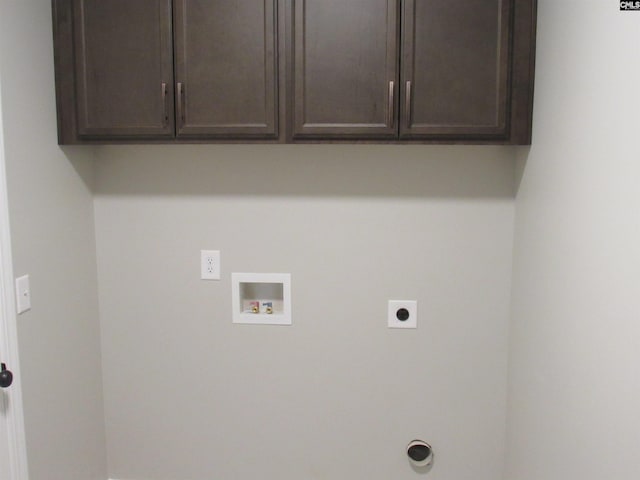 washroom featuring hookup for an electric dryer, washer hookup, and cabinets