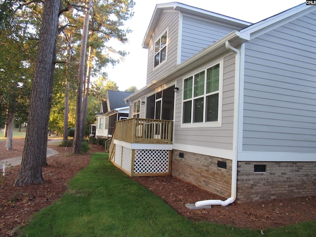 view of side of home with a yard