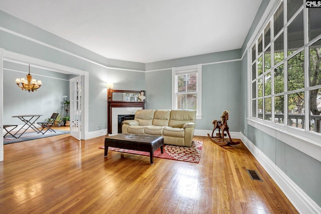 living room with hardwood / wood-style floors and a notable chandelier