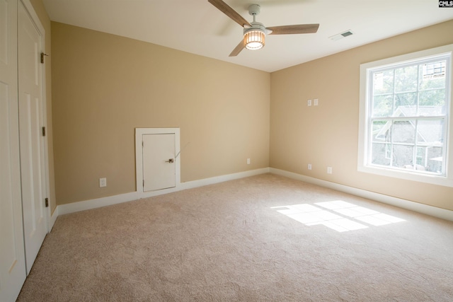 spare room with light carpet and ceiling fan