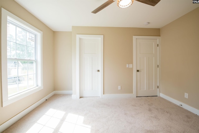 unfurnished bedroom featuring light carpet and ceiling fan