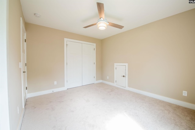 unfurnished bedroom with a closet, ceiling fan, and light colored carpet