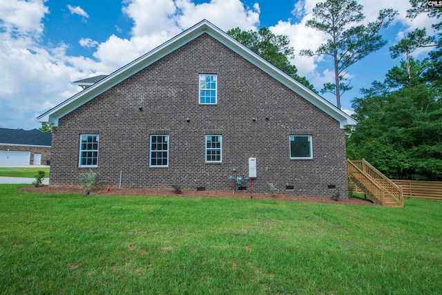 rear view of house featuring a yard