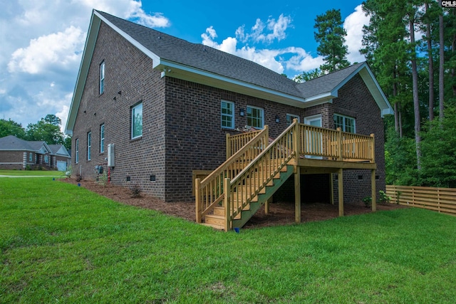 back of house with a yard and a deck