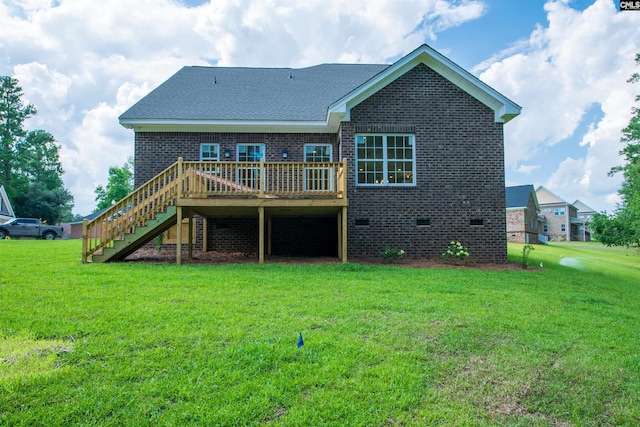 back of property with a wooden deck and a lawn