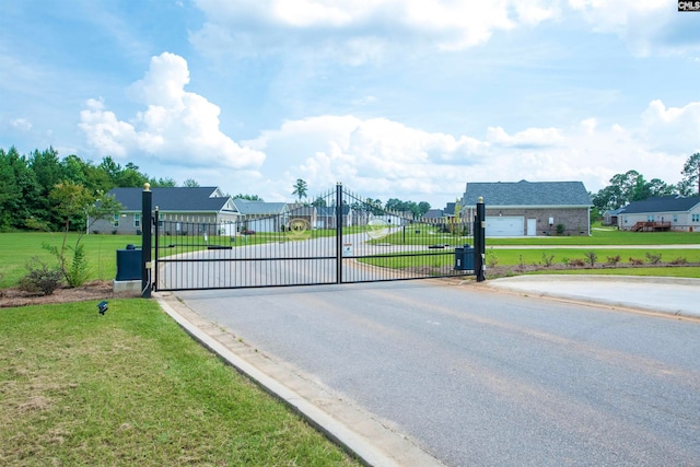 view of gate featuring a yard