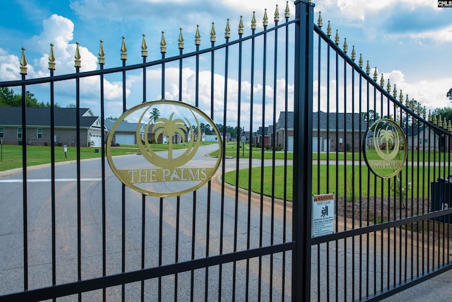 view of gate with a yard