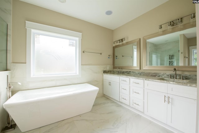 bathroom featuring vanity, plus walk in shower, and tile walls