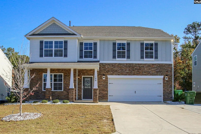 view of front of property featuring a front yard and a garage