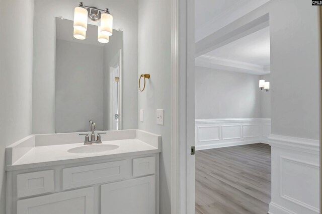 bathroom with vanity, a chandelier, and hardwood / wood-style flooring