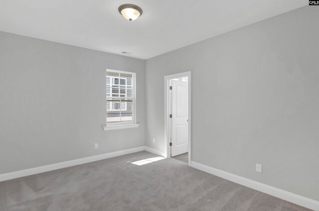 unfurnished room with light carpet