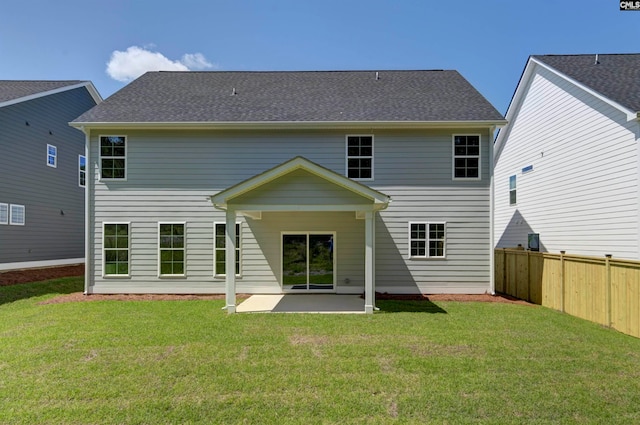 rear view of property with a yard and a patio area