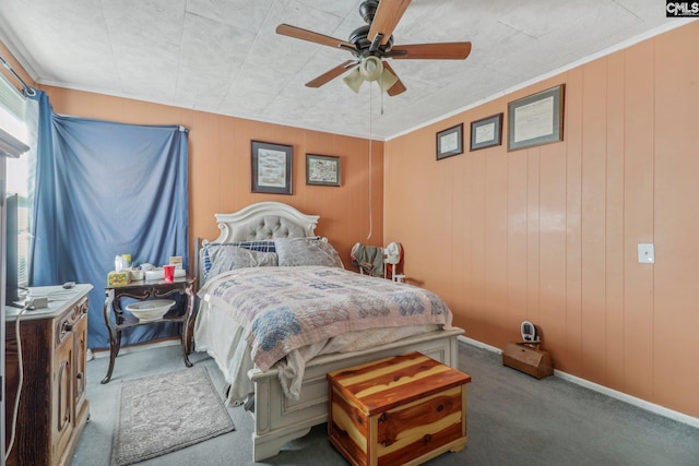 carpeted bedroom with wood walls and ceiling fan