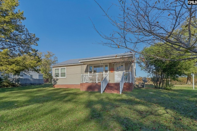 back of property with a porch and a lawn