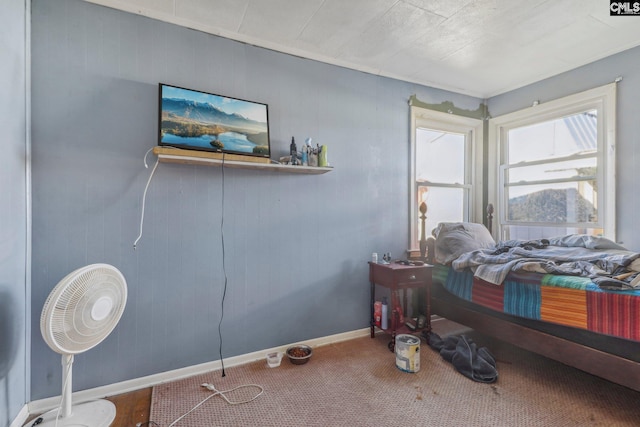 bedroom featuring wooden walls