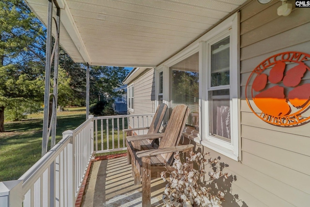 wooden deck featuring a lawn