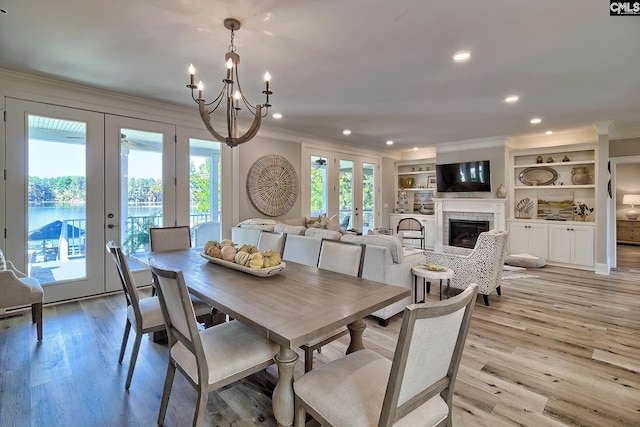 dining space with french doors, light hardwood / wood-style flooring, and a healthy amount of sunlight