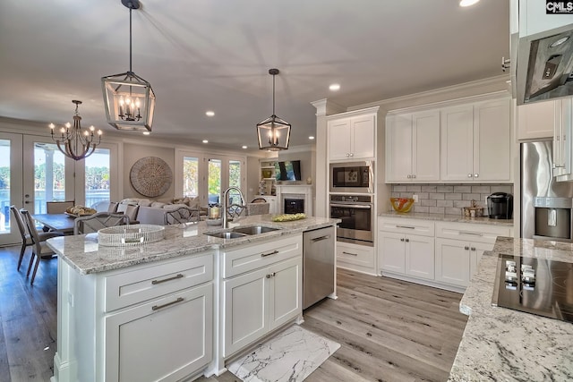 kitchen with sink, french doors, appliances with stainless steel finishes, and white cabinetry