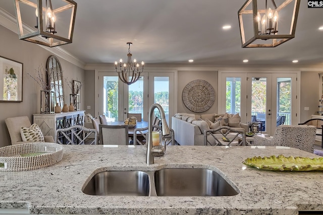 kitchen with french doors, a healthy amount of sunlight, sink, and light stone counters