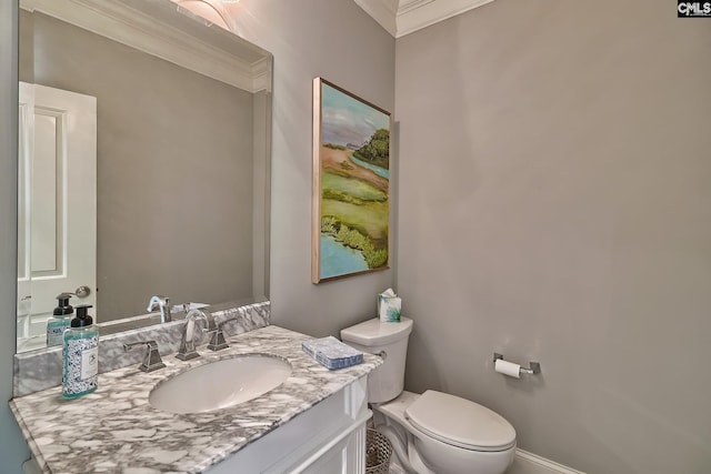 bathroom featuring toilet, crown molding, and vanity