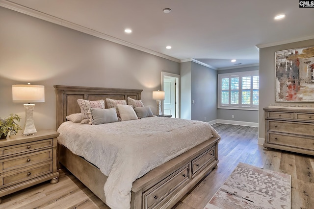 bedroom featuring light hardwood / wood-style flooring and crown molding