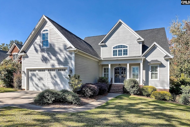 view of property with a front lawn and a garage