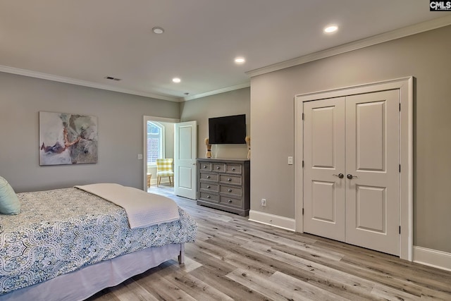 bedroom with a closet, crown molding, and light wood-type flooring