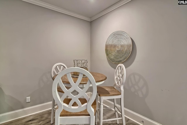 dining area with crown molding and wood-type flooring