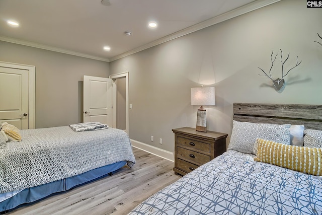 bedroom with crown molding and light wood-type flooring