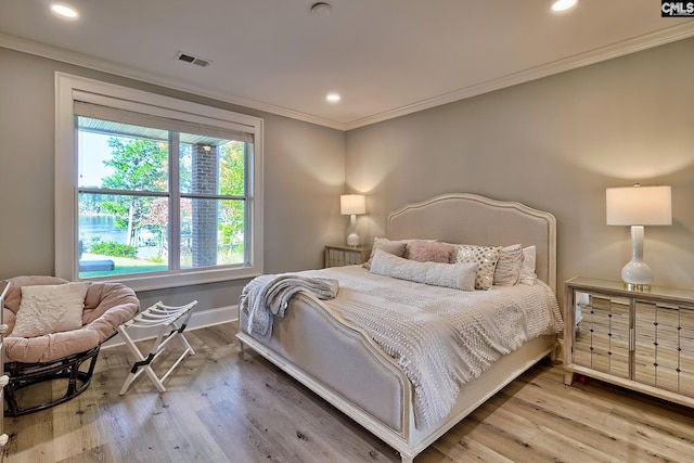 bedroom featuring ornamental molding and hardwood / wood-style flooring