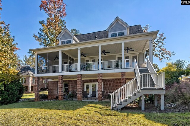 rear view of house with french doors, a yard, and ceiling fan