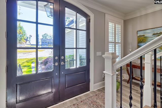 doorway with french doors, hardwood / wood-style flooring, and a wealth of natural light