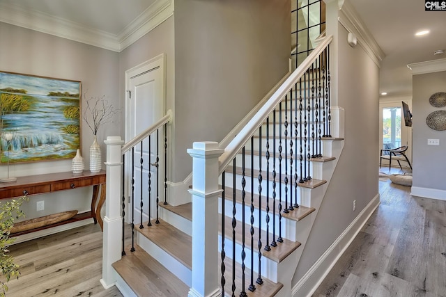 staircase featuring crown molding and hardwood / wood-style flooring