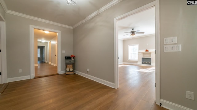 101 Dinkins Place Rd, Blythewood, SC 29130 - empty room with ornamental molding, ceiling fan, wood finished floors, baseboards, and a glass covered fireplace