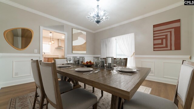 101 Dinkins Place Rd, Blythewood, SC 29130 - dining room featuring ornamental molding, wainscoting, a decorative wall, dark wood-type flooring, and a chandelier