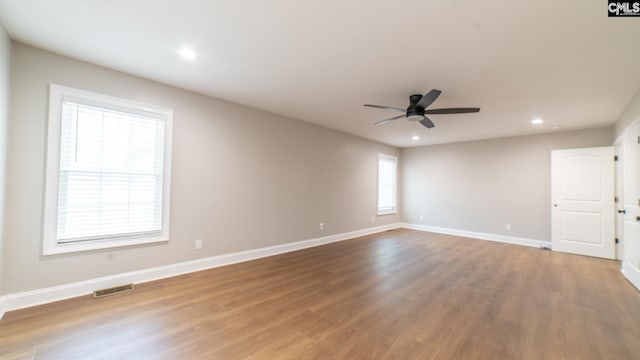 spare room featuring ceiling fan and hardwood / wood-style floors