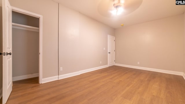 unfurnished bedroom with wood-type flooring and ceiling fan