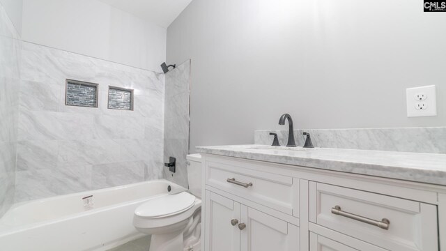 full bathroom featuring vanity, toilet, and tiled shower / bath